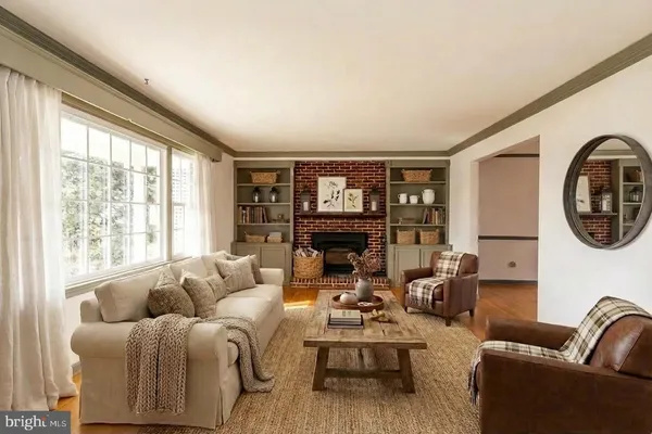 a view of an empty room with a fireplace and a window