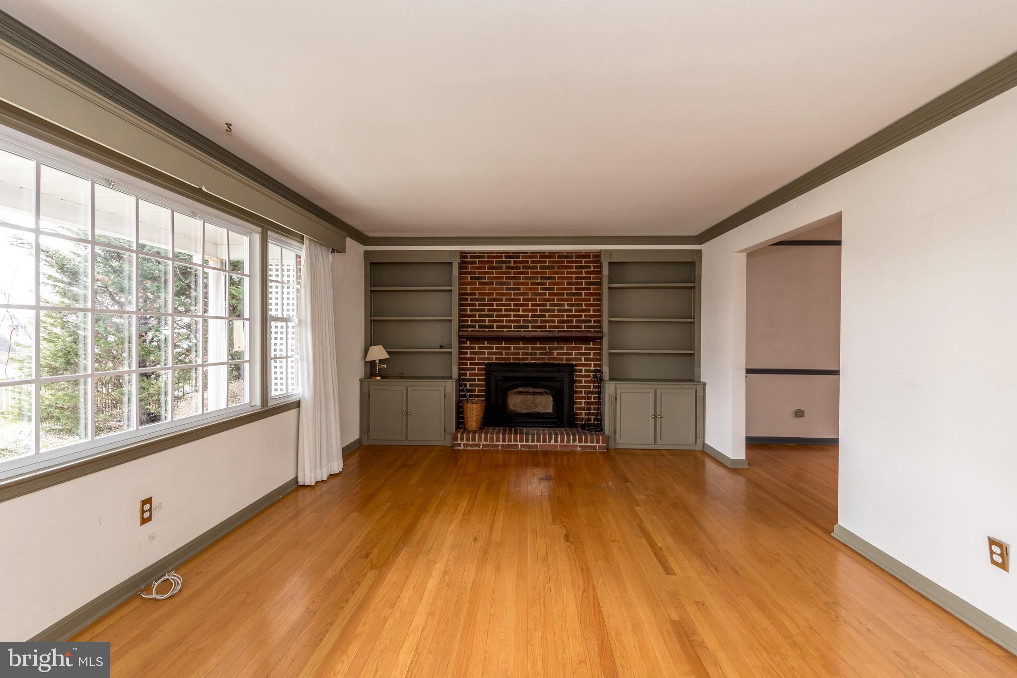 4300 Camellia Road Nottingham, MD 21236 - Photo 7 of 47 a view of an empty room with a fireplace and a window