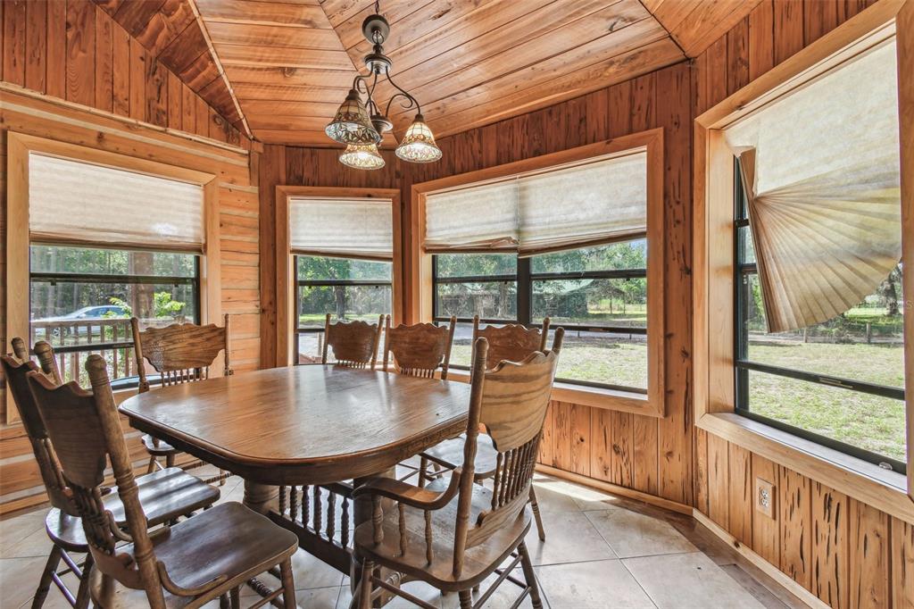19708 Bower Road Dade City, FL 33523 - Photo 11 of 84 a dining room with furniture large windows and a chandelier