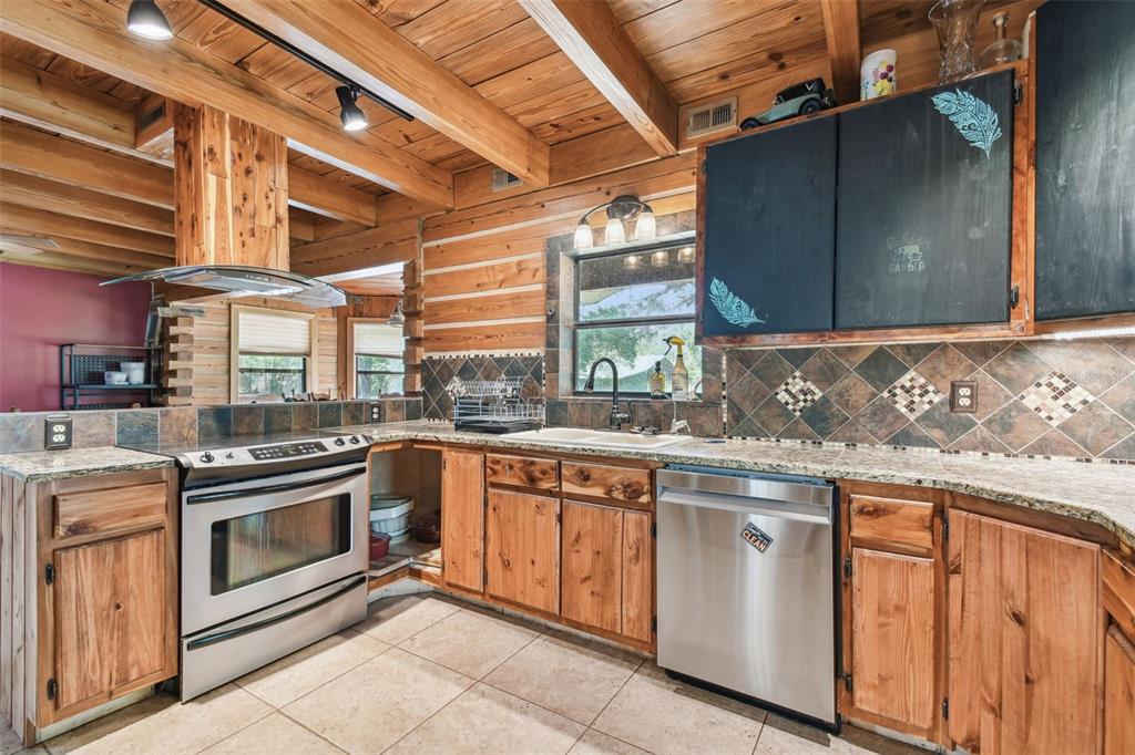 19708 Bower Road Dade City, FL 33523 - Photo 12 of 84 a kitchen with a stove sink and cabinets