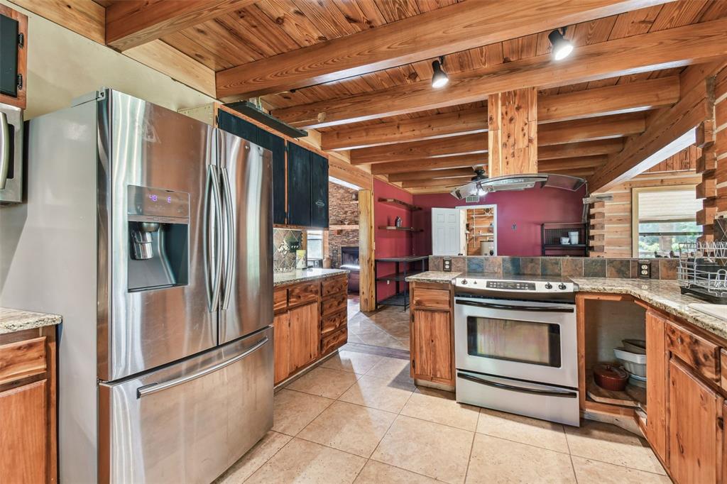 19708 Bower Road Dade City, FL 33523 - Photo 13 of 84 a kitchen with stainless steel appliances granite countertop a refrigerator a stove and a sink