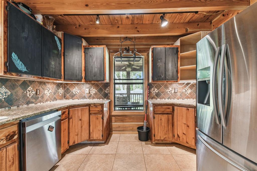 19708 Bower Road Dade City, FL 33523 - Photo 14 of 84 a kitchen with stainless steel appliances granite countertop a refrigerator and a sink