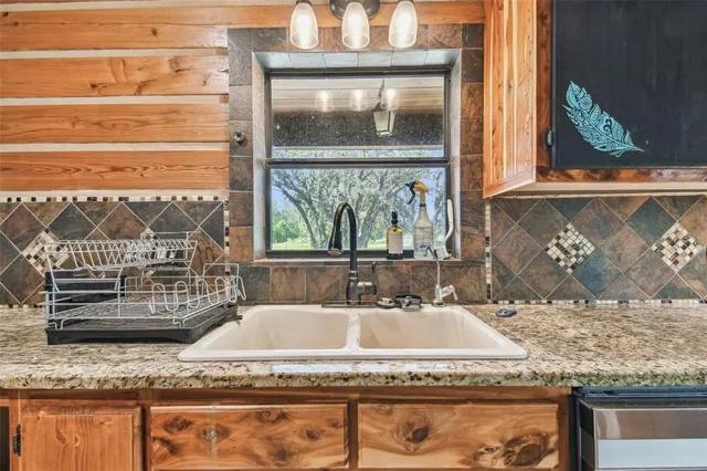 a room with pool table and windows