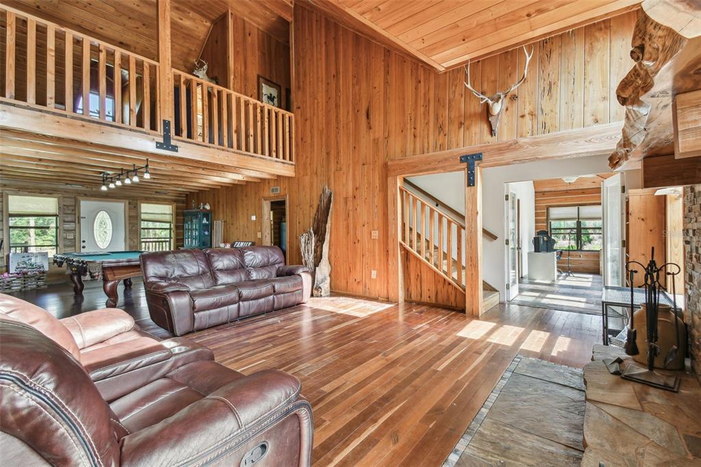 19708 Bower Road Dade City, FL 33523 - Photo 18 of 84 a view of a patio with couches a table and chairs with wooden floor