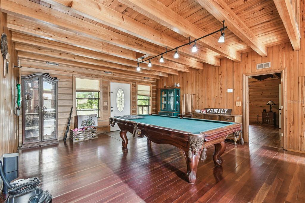 19708 Bower Road Dade City, FL 33523 - Photo 23 of 84 a room with wooden floors table and chairs