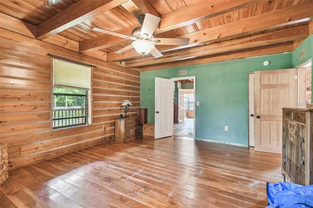 a view of a porch with wooden floor in front of house
