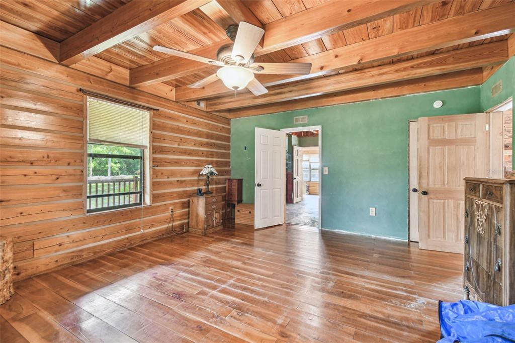 19708 Bower Road Dade City, FL 33523 - Photo 29 of 84 a view of an empty room with wooden floor and a window