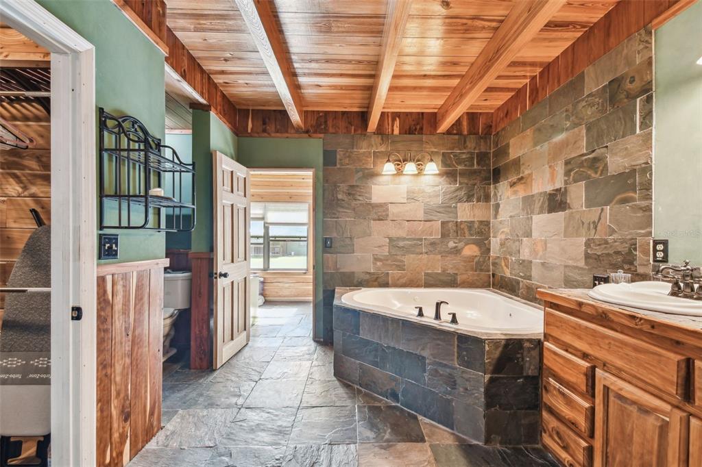 19708 Bower Road Dade City, FL 33523 - Photo 30 of 84 a bathroom with a tub a sink and a shower