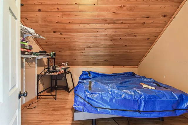 a bed sitting in a bedroom next to a window