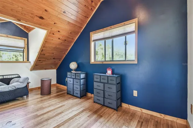 a bedroom with a bed and flat screen tv