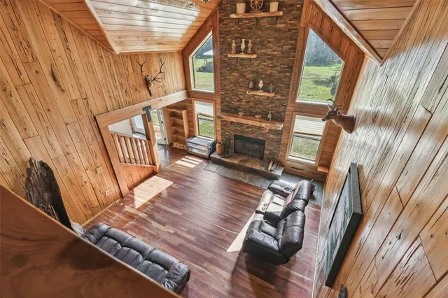 a view of a backyard with table and chairs under an umbrella