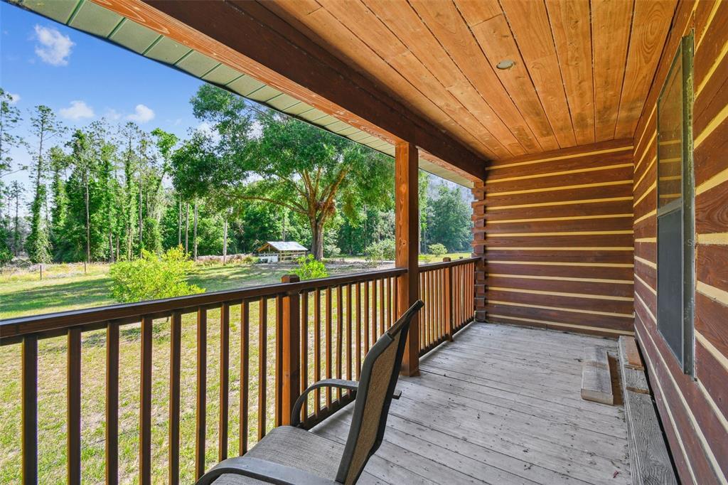 19708 Bower Road Dade City, FL 33523 - Photo 47 of 84 a view of a porch with wooden floor in front of house