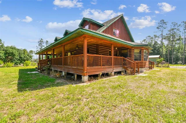a dining room with furniture large windows and wooden floor