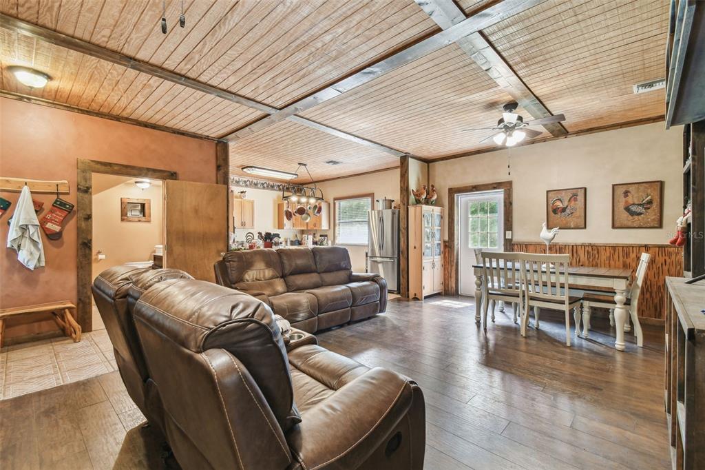 19708 Bower Road Dade City, FL 33523 - Photo 52 of 84 a living room with furniture wooden floor and kitchen view