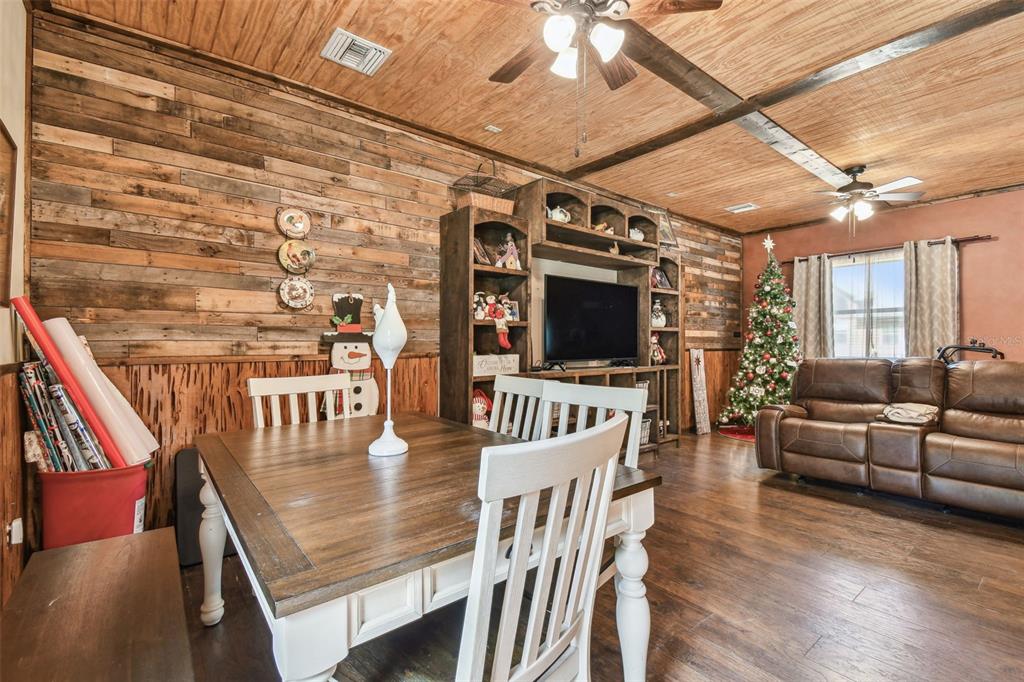 19708 Bower Road Dade City, FL 33523 - Photo 54 of 84 a view of a dining room with furniture wooden floor and chandelier