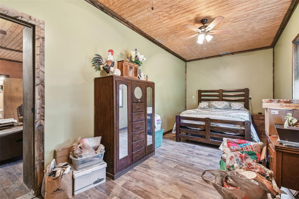 19708 Bower Road Dade City, FL 33523 - Photo 58 of 84 a bedroom with furniture and a chandelier