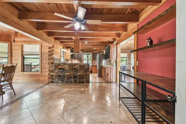 a kitchen with stainless steel appliances granite countertop a refrigerator a stove and a sink