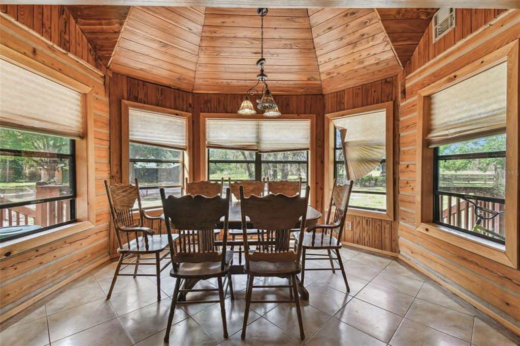 19708 Bower Road Dade City, FL 33523 - Photo 10 of 84 a dining room with furniture large windows and wooden floor
