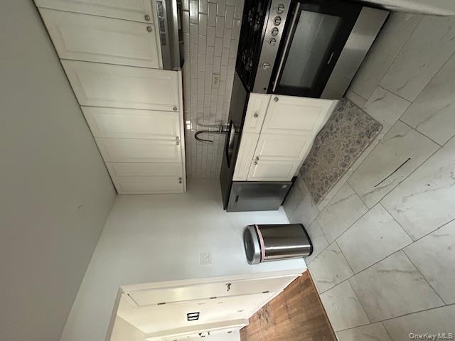 330 East Broadway, Unit 101 Long Beach, NY 11561 - Photo 1 of 1 a kitchen with stainless steel appliances granite countertop a sink stove and cabinets
