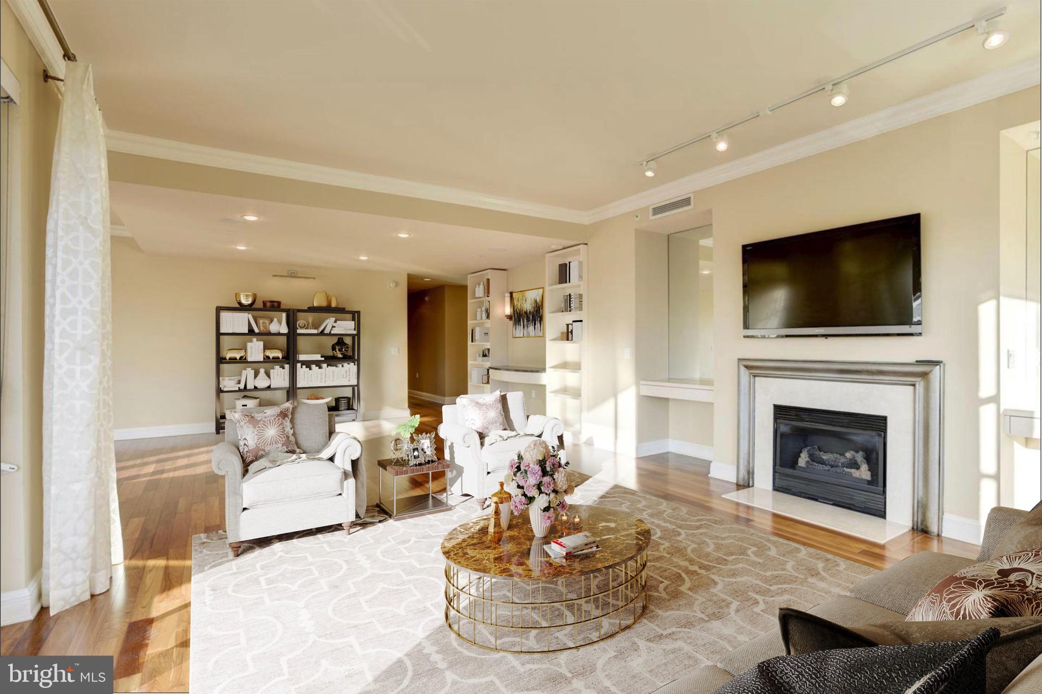 801 Key Highway, Unit 413 Baltimore, MD 21230 - Photo 1 of 58 a living room with furniture a fireplace and a flat screen tv