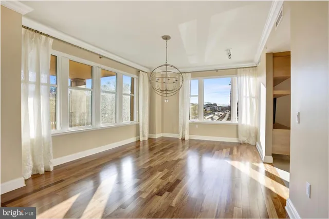 a view of an entryway with wooden floor and windows