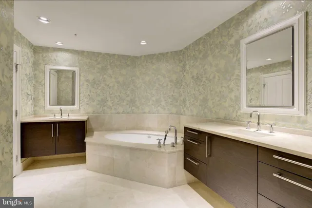 a white toilet sitting next to a white wall