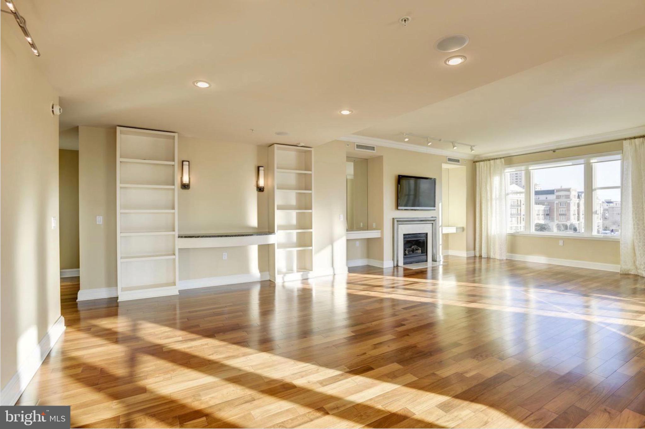 801 Key Highway, Unit 413 Baltimore, MD 21230 - Photo 4 of 58 a view of empty room with wooden floor and floor to ceiling window