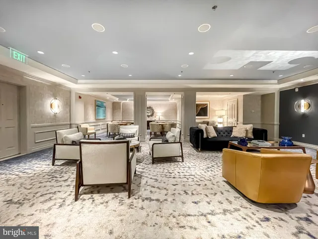 a living room with furniture and a dining table with kitchen view