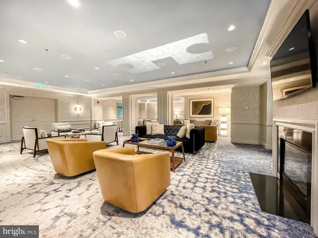a living room with a couch and a dining table with kitchen view