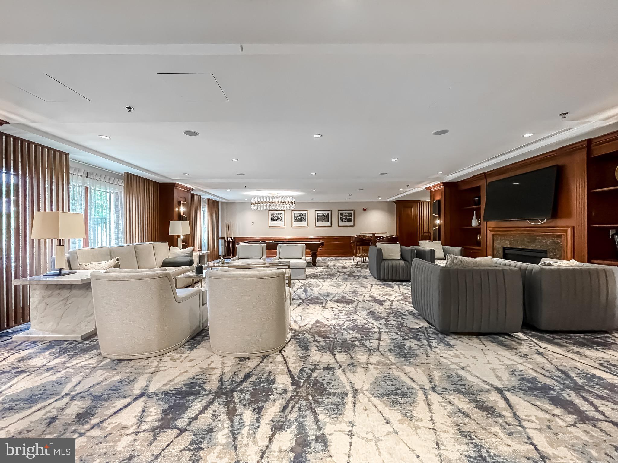 801 Key Highway, Unit 413 Baltimore, MD 21230 - Photo 52 of 58 a living room with a couch and a dining table with kitchen view