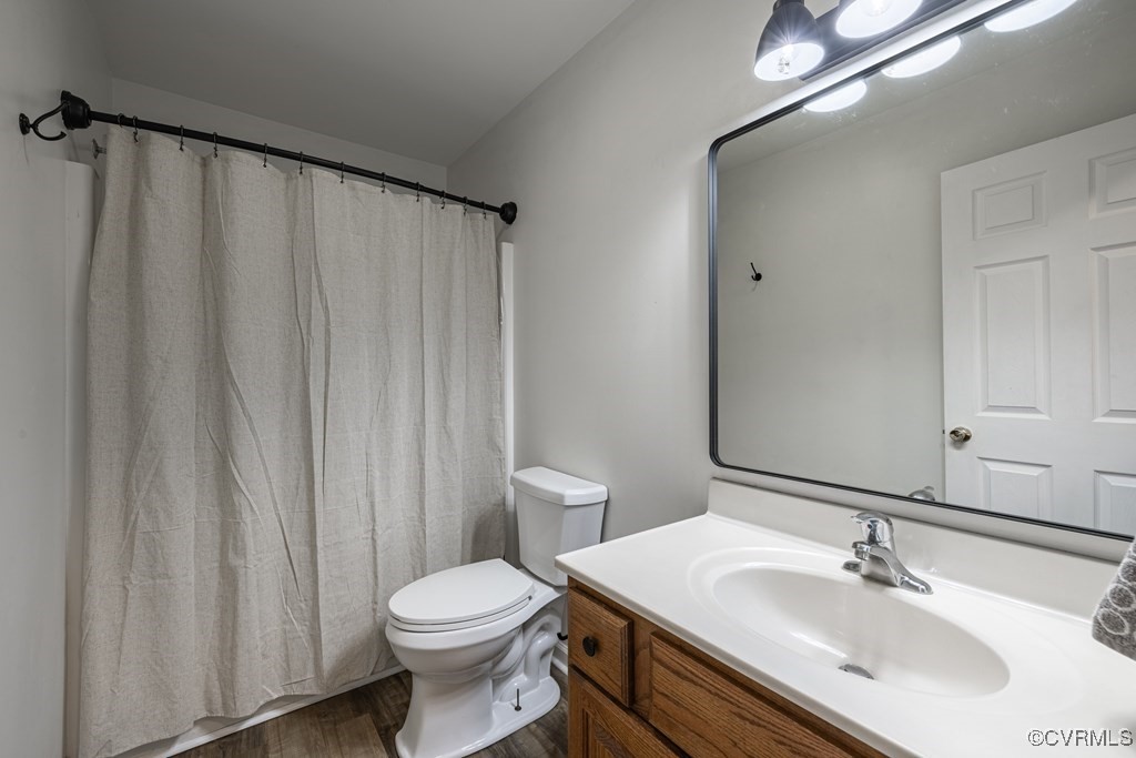11272 Farmville Road Meherrin, VA 23954 - Photo 27 of 36 Bathroom featuring vanity, toilet, and wood finish