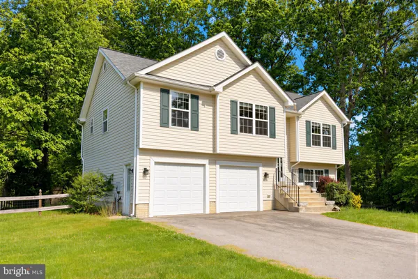 a front view of a house with a garden and yard