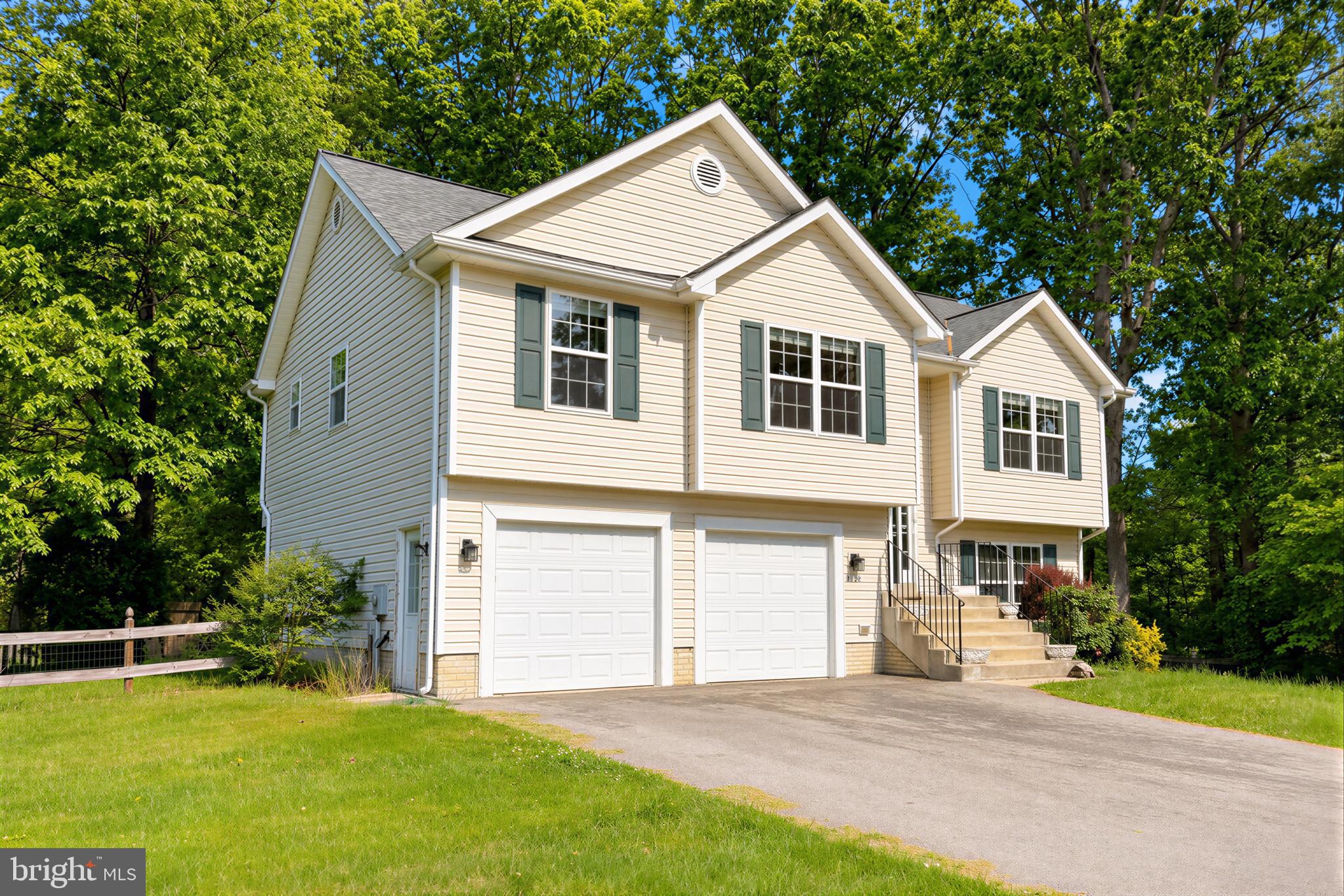 23801 McIntosh Road Hollywood, MD 20636 - Photo 1 of 35 a front view of a house with a garden and yard