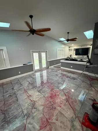 a open kitchen with kitchen island a stove a sink and a counter top space