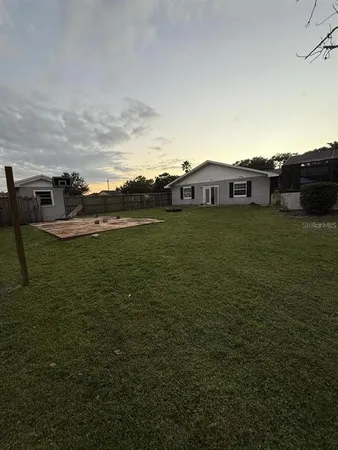 a backyard of a house with lots of green space and mountain view in back