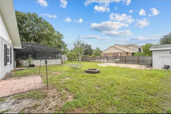 a view of yard with swimming pool and outdoor seating