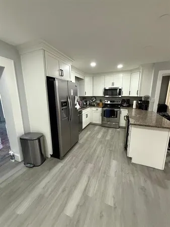 a kitchen with refrigerator and microwave