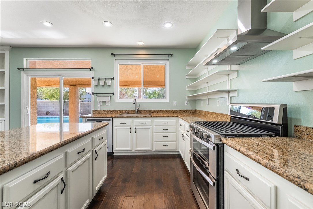 261 Timber Hollow Street Henderson, NV 89012 - Photo 19 of 51 Culinary delights await in this light-filled kitchen with rich wood flooring and direct outdoor access.