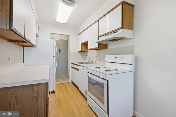 a kitchen with cabinets and steel appliances