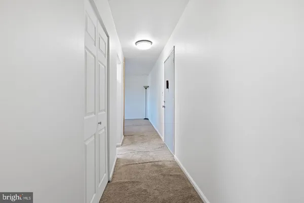 a view of a hallway with a door