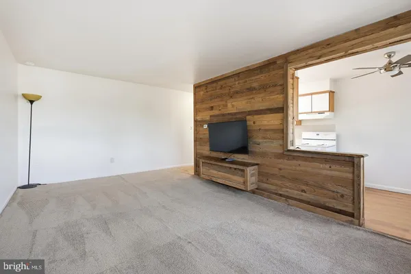 a view of room with window and flat screen tv