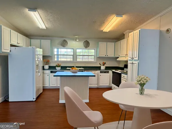 a white bath tub sitting in a bathroom next to a toilet