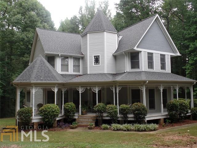 2000 Flat Rock Road Stockbridge, GA 30281 - Photo 1 of 1 a front view of a house with a yard potted plants and a table