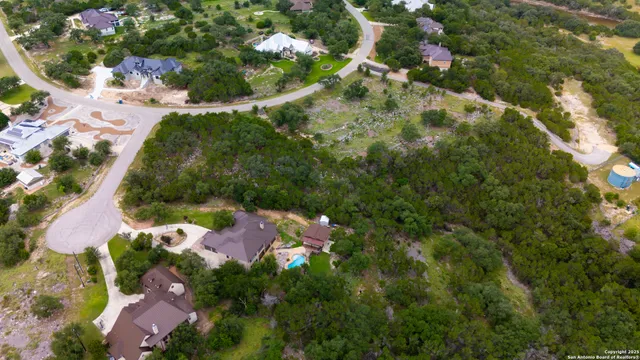 a aerial view of a house with swimming pool and garden