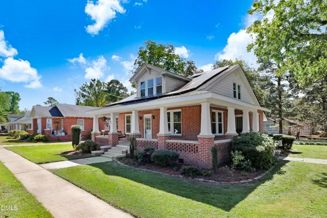 a front view of a house with a yard table and chairs