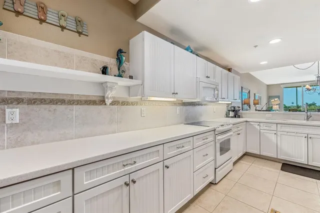 a kitchen with cabinets and appliances