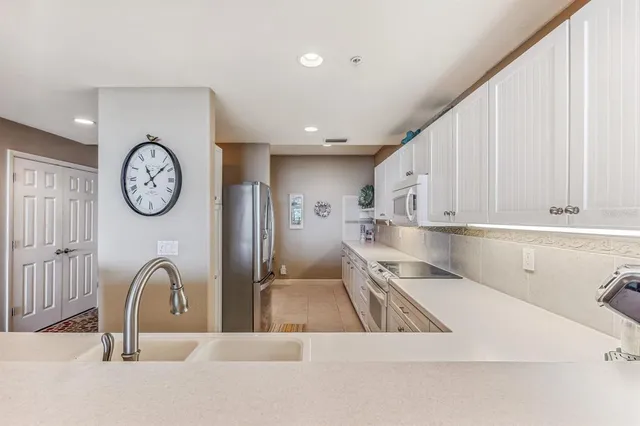 a view of a kitchen with faucet and cabinets