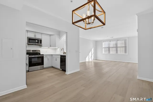 a kitchen with stainless steel appliances a refrigerator and a stove top oven