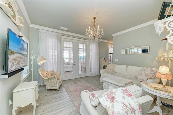 a living room with furniture and a chandelier