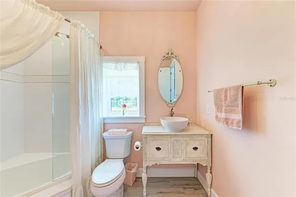 a bathroom with a toilet a sink and a mirror